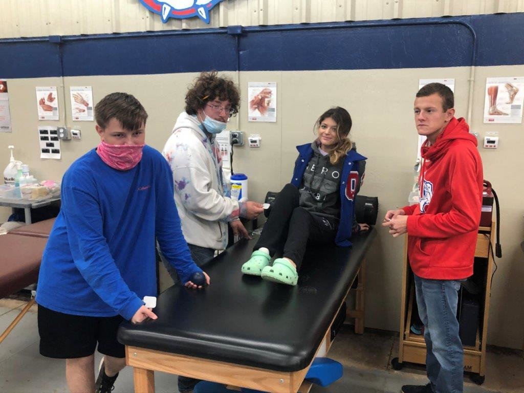 Students involved in the sports medicine at one of the several training tables in their facility at Quitman High School. They are (left to right) Blaze Spann, Brenden Mattox, Gracie Saveera and Ethan Phillips. (Monitor photo by Larry Tucker)